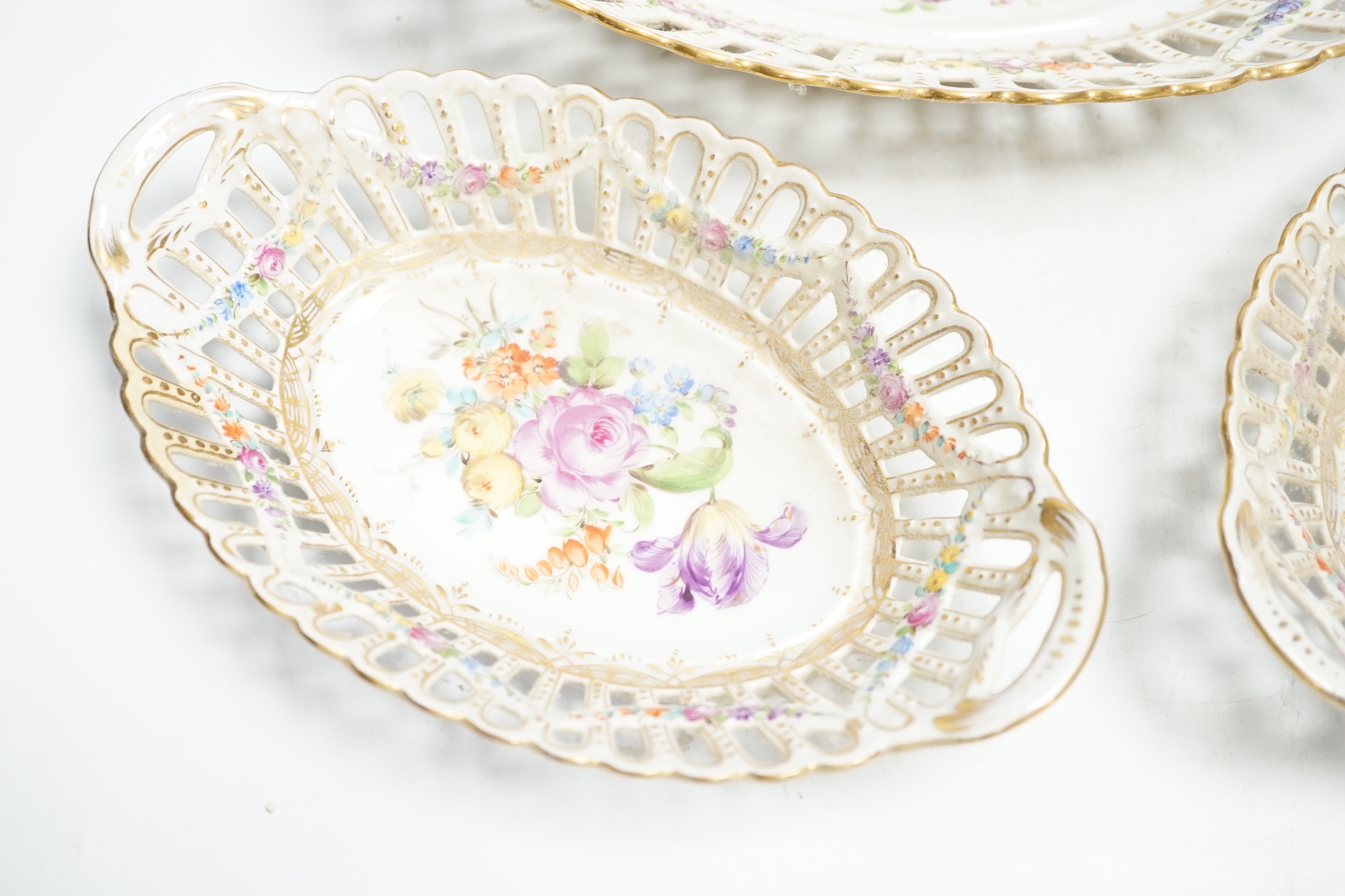 A trio of Dresden pierced floral painted porcelain oval baskets